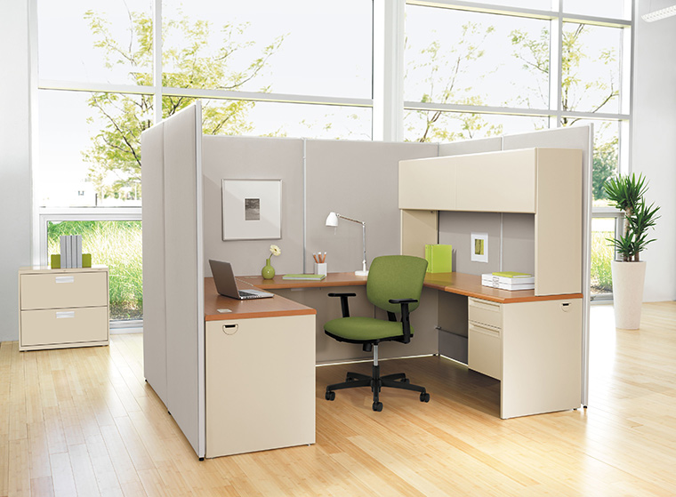 Cubicle space with green chair and supplies