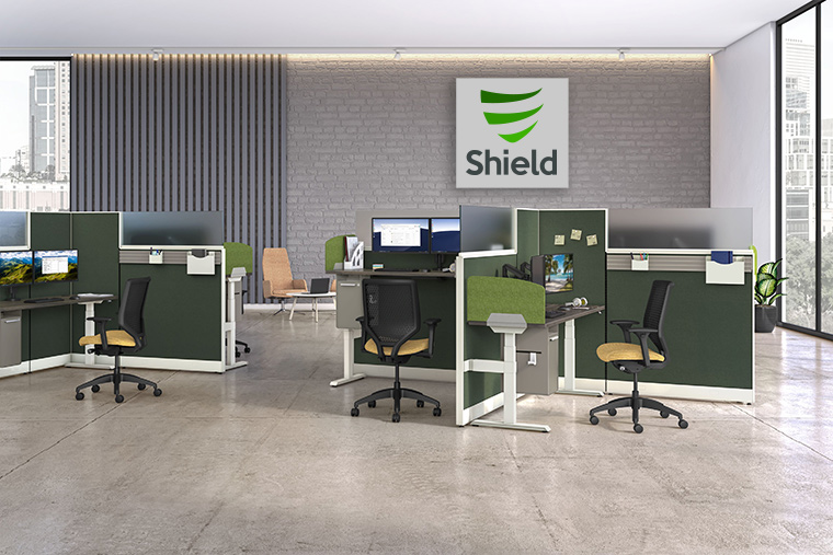 Open office space with company logo Shield in the background