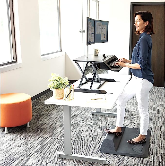 Woman working at a sit-stand desk