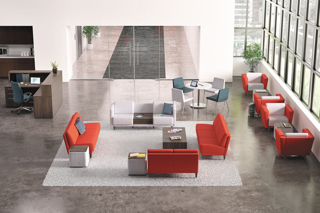 Open reception area with red chairs and couches