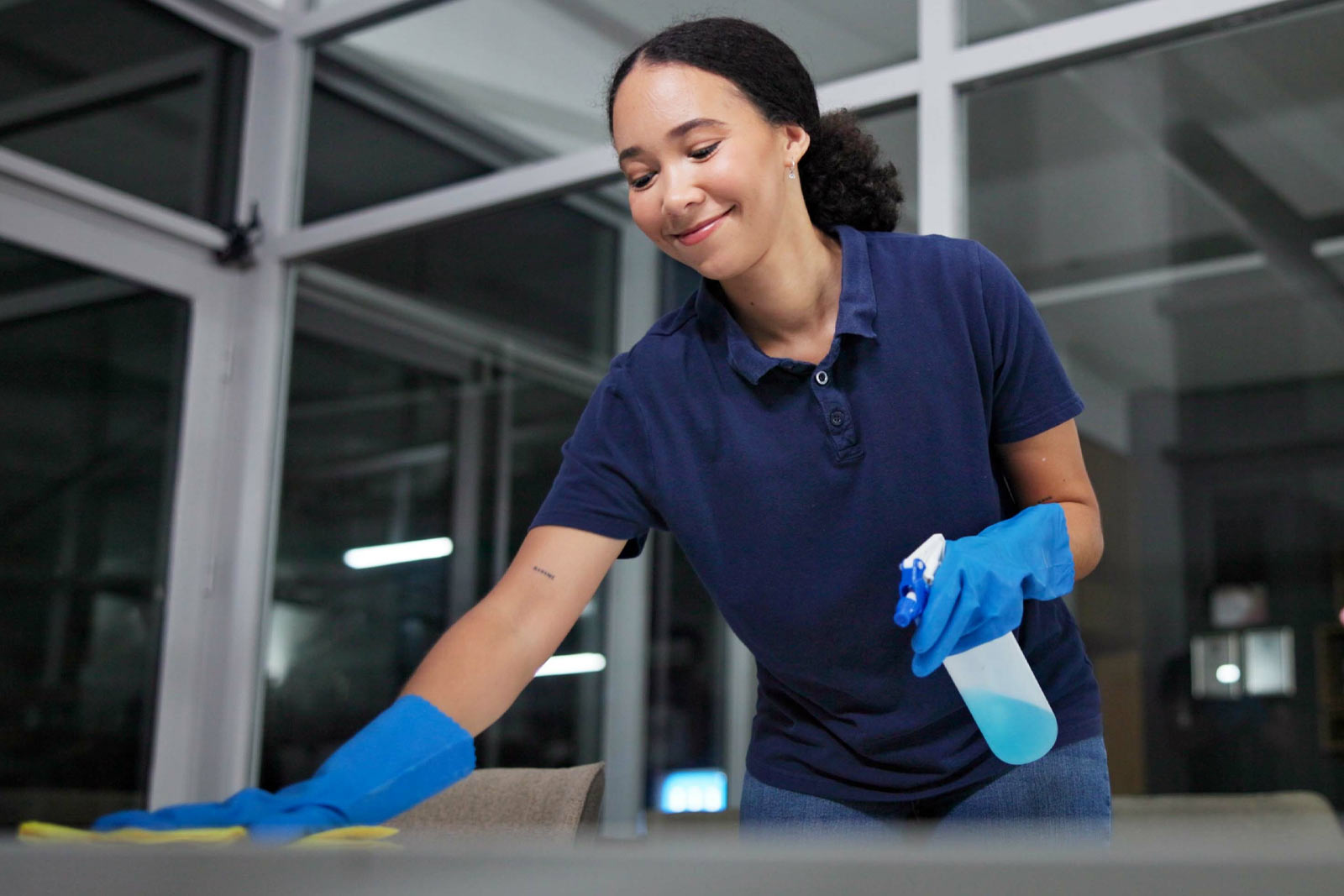 Woman cleaning office desk.